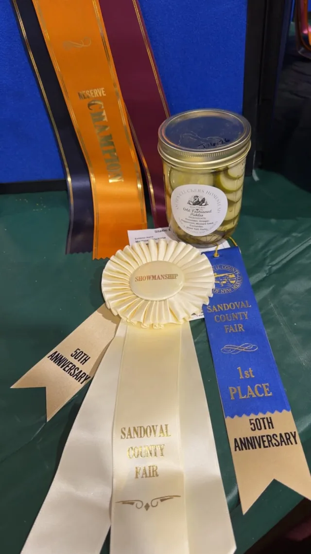 A jar displayed alongside award ribbons