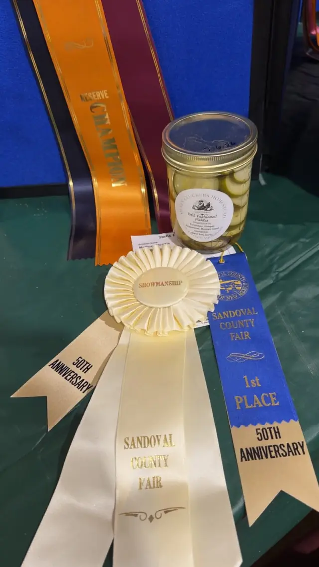 A jar displayed alongside award ribbons