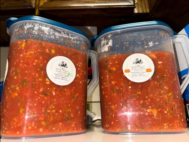 Two containers of Queen Cluckers salsa