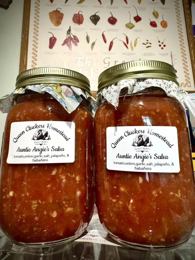 Two labeled jars of Queen Cluckers salsa